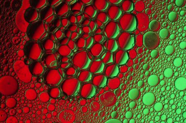 Cellular shapes in a red and green abstract background clipart