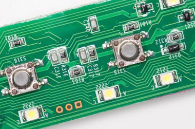 Resistors switches and LEDs on a printed circuit board clipart