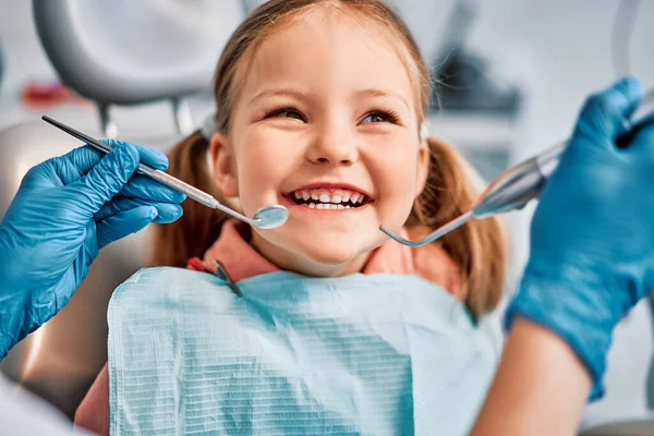 Children's dentistry. Live funny photo of a laughing child at the dentist's appointment.