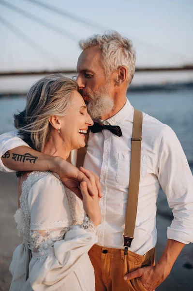 Snygga Par Äldre Nygifta Står Omfamnande Flodstranden Mannen Kysser Kvinnan — Stockfoto
