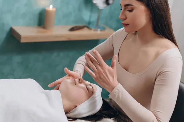 Beautician Makes Facial Massage Young Woman Lies Her Back Gets — Stock Photo, Image