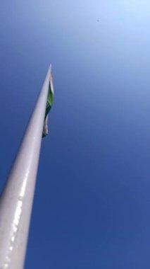 Flag of India viewed from bottom of the flag pole on a hot sunny day