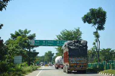 A Road Direction Board on National Highway 37 of Assam showing distance of places
