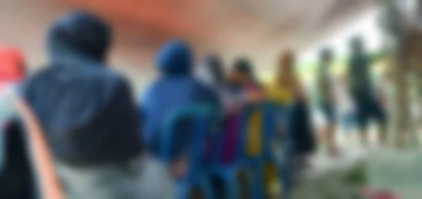 Blur photo of people standing in line