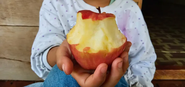 Bite apple holding by a child
