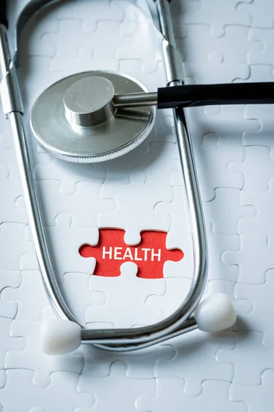 White puzzle with an exposed spot and a bright note on a red background. Health, Medical concept, health promotion, preventive examinations, healthy lifestyle