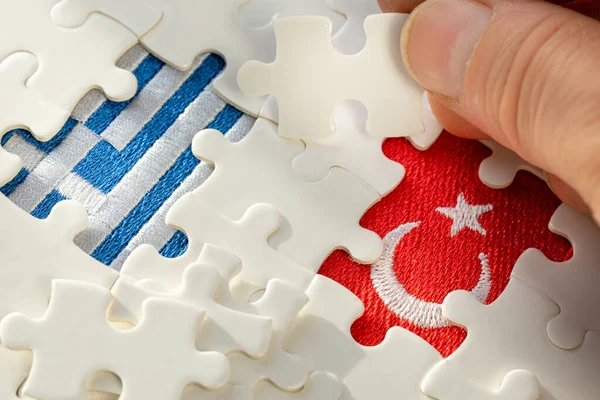 the puzzle reveals the flags of Turkey and Greece, Concept, Mutual relations of both countries, Growing conflict between members of the North Atlantic Treaty Organization
