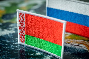 The flag of Belarus and the flag of Russia in the background, concept, Mutual relations of the two countries, Economic dependence of Belarus
