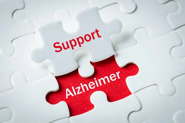 alzheimer\'s disease, Puzzle with exposed words Support and alzheimer, Concept, Help and support for elderly people struggling with progressive neurodegenerative disease