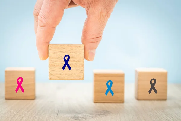 Fight cancer, Colorful ribbons on wooden cubes background, Symbol of fight against disease, cure cancer, cancer awareness day,brain tumor,breast cancer, Health care and cancer research concept