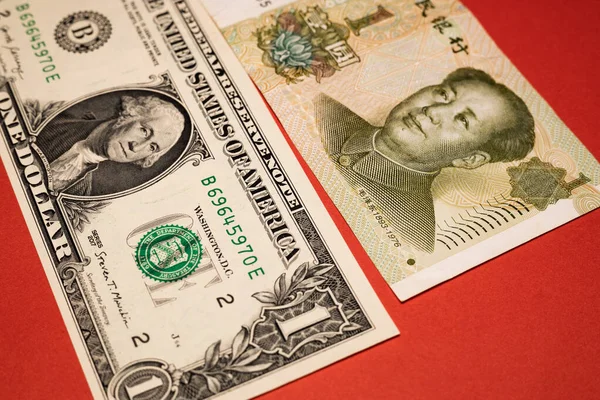 Banknotes of one Chinese yuan and One US dollar, Financial concept, Economic and financial competition, Global currency market, red bacground, close up