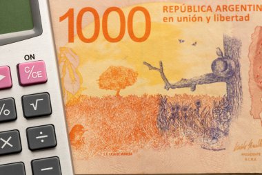Arjantin parası, bin Arjantin pezosu banknot ve hesap makinesi, finansal hesaplama konsepti, kapan, düz yat