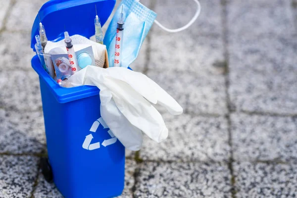Medical waste concept, Open garbage full of pills, syringes, bandages, masks, protective gloves. Utilization and storage of hospital waste
