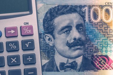 Peru money, 100 soles banknote and calculator, Financial calculations concept, close up clipart