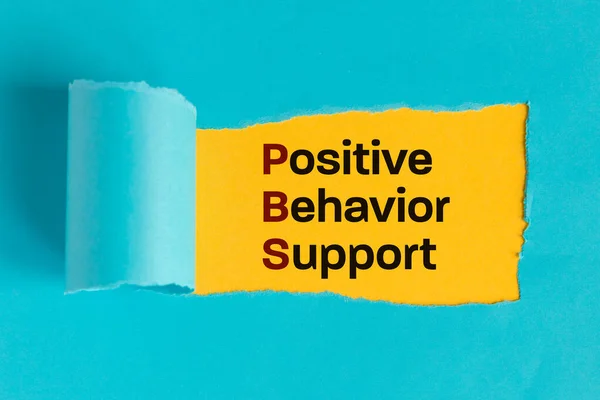 Pozitif Davranış Destek Sembolü Yırtık Kağıt Arkasında Ortaya Çıkan Metin — Stok fotoğraf