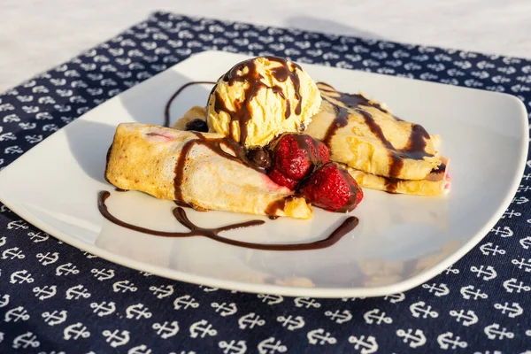 Palacsinta, traditional Hungarian sweet pancakes served with fruit and a scoop of ice cream, Delicious dessert