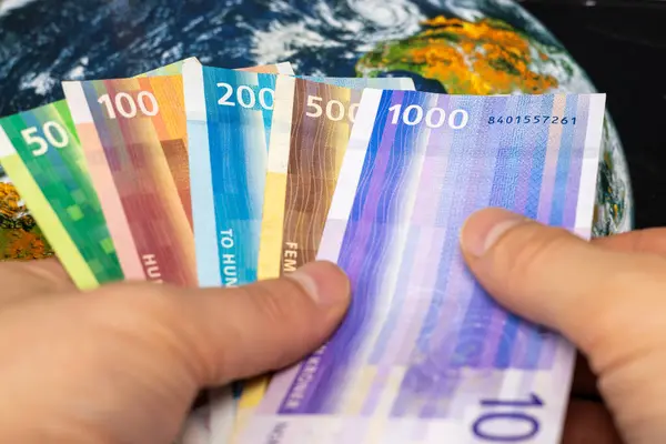 Norwegian money, held in hand, world currencies, business finance concep