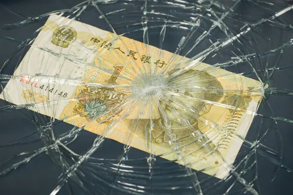 China money, Fall of Chinese currency, Weakening Yuan 1 Yuan banknote lying behind broken glass, Financial concept or insurance costs