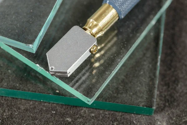 Glass cutting tool lying on the glass, Work and tools of a glazier