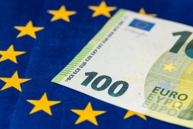 100 euro banknote against the background of the flag of the European Union, EU financial concept, Joining the euro zone, Common monetary polic clipart