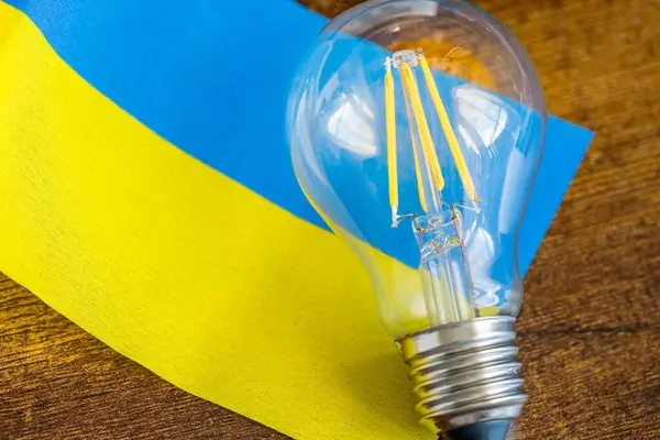 Una Bombilla Brillante Que Yace Medio Bandera Ucrania Concepto Problemas — Foto de Stock