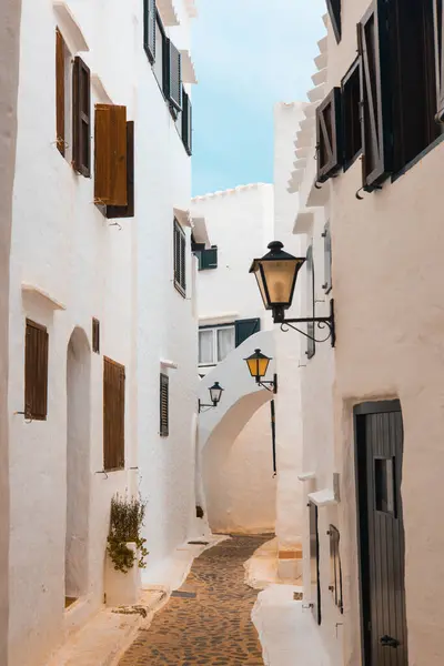 stock image The beautiful picturesque village of Binibeca on Menorca. White plastered house walls with wooden elements. A charming town in Spain on the Balearic Islands