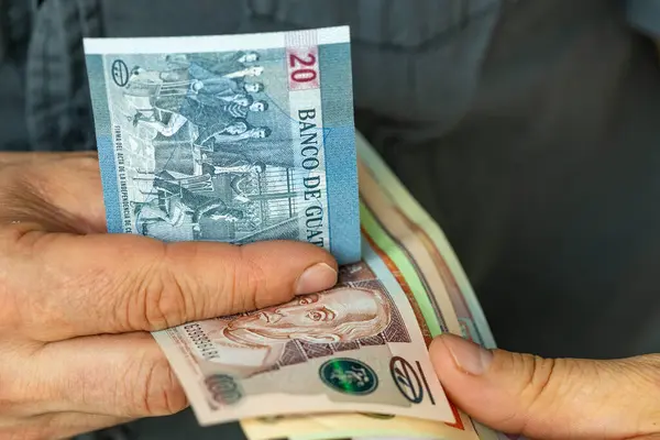 Stock image Guatemala money, Man counting quetzales banknotes, Financial business concept, Means of payment in Latin America