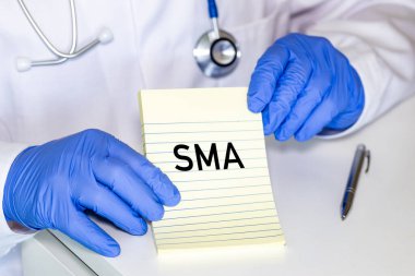 SMA hastalığı, Doktor defterde SMA Genetik yazıyor. Omurilik kasları körelmesi. Sağlık kavramı