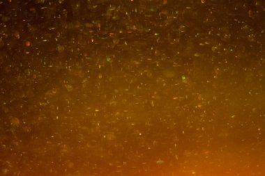 Abstract golden background with sparkles and shadows. Fluidity, waves, glitter, fluid, glitter, shimmer. Gold, glitter, glitters, sequins, golden, sequins, light bulbs, light.