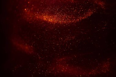 Abstract red background with sparkles and shadows. Fluidity, waves, glitter, fluid, glitter, shimmer.