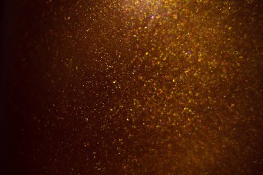 Abstract shiny golden background. Glitter, fluidity, waves, smoke, gold, glitter.