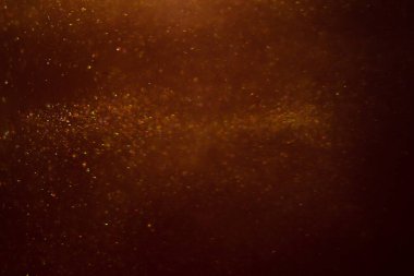 Abstract shiny golden background. Glitter, fluidity, waves, smoke, gold, glitter.