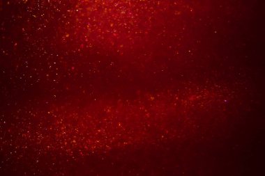 Abstract red background with sparkles and shadows. Fluidity, waves, glitter, fluid, glitter, shimmer.