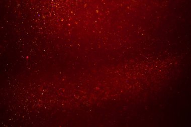 Abstract red background with sparkles and shadows. Fluidity, waves, glitter, fluid, glitter, shimmer.