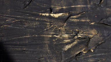 Ornament dark rough sections with shiny gold