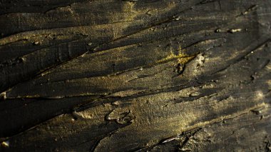 Photo-relief dark rough stripes with golden shine