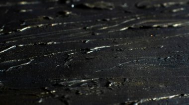 Microtexture black relief strokes with golden plating