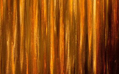 Abstract striped background. Golden stripes. Shadow, gold, yellow, orange, gold. Trees, stripes, lines, vertical.