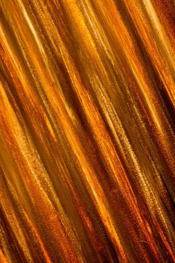 Abstract striped background. Golden stripes. Shadow, gold, yellow, orange, gold. Trees, stripes, lines, vertical.