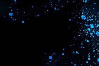 Black background with drops, dots, blots, megumi and dust. Of blue color.