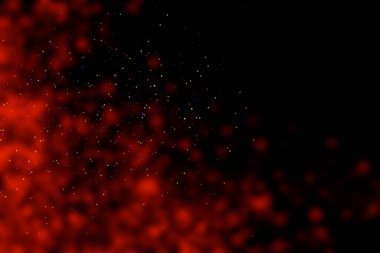 Black background with red stains, blur. Multi-colored sequins, stars, dust, glitter.