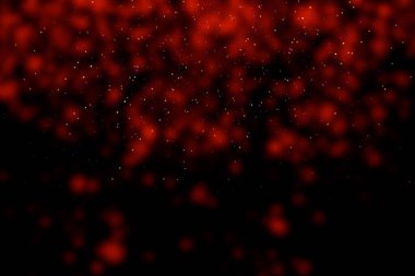 Black background with red stains, blur. Multi-colored sequins, stars, dust, glitter.