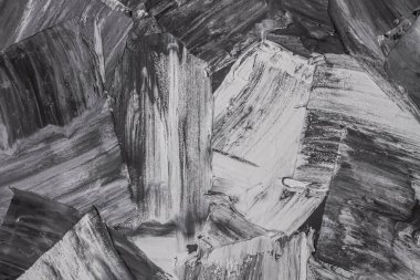 Rough strokes with a spatula. Plaster, painting. Gypsum, cement, wall. View. Substrate, under For an inscription. Grey, black and white.