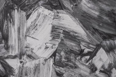 Rough strokes with a spatula. Plaster, painting. Gypsum, cement, wall. View. Substrate, under For an inscription. Grey, black and white.