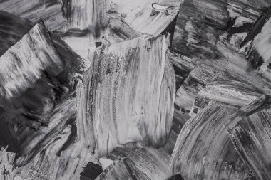 Rough strokes with a spatula. Plaster, painting. Gypsum, cement, wall. View. Substrate, under For an inscription. Grey, black and white.