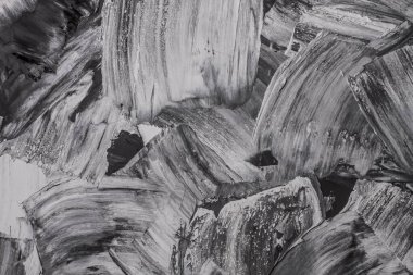 Rough strokes with a spatula. Plaster, painting. Gypsum, cement, wall. View. Substrate, under For an inscription. Grey, black and white.