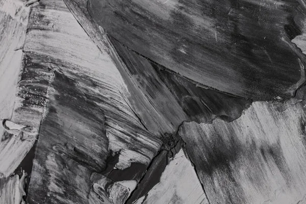 Rough strokes with a spatula. Plaster, painting. Gypsum, cement, wall. View. Substrate, under For an inscription. Grey, black and white.