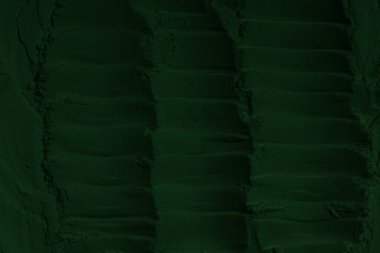 Küresel ısınma kavramı, tasarlamak için alanı olan siyah yeşil arka plan. Eski bir taş duvarın kabataslak yüzeyi. Yakın plan. Koyu yeşil zümrüt rengi. Geçmişi. Katı. Grunge. yeşil göz farı. Kraterler. yeşil toprak