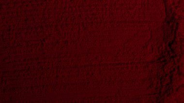 Kırmızı doku. Barut arkaplanı. Pedra, kum. Kırmızı renk. Koyu kırmızı. Yoğun koyu kırmızı. Çatlaklar, dalgalar, çizgiler, daireler, depresyonlar. Dışbükey. Afiş, reklam, yazı için.