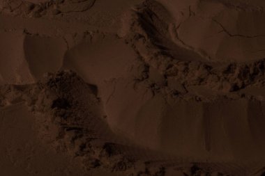 Kil, kum, toprak dokusu. Kahverengi. Geçmişi. Çatlak, çatlak, dalga, dağ, çember, oyuk. girintilenmiş